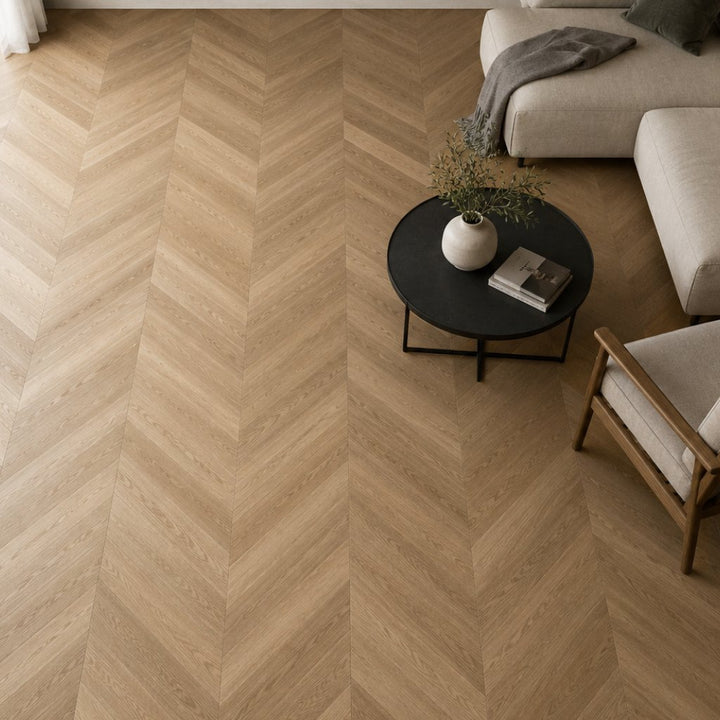 Chevron Designboden SolidLock silent 70-05 Versailles Braun – moderne Wohnzimmer-Verlegung von oben mit durchgehendem V-Muster, elegante Holzoptik und raumöffnender Effekt - Reud Bodenarena