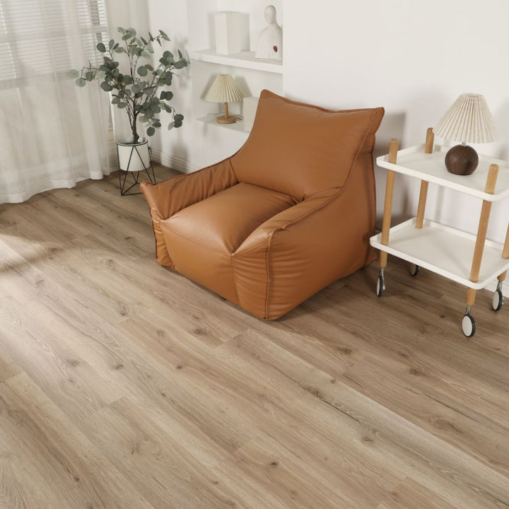 Klick Vinyl Eiche Kern in naturbeiger Eichenoptik im Wohnraum mit Ledersessel und Servierwagen von Reud Bodenarena