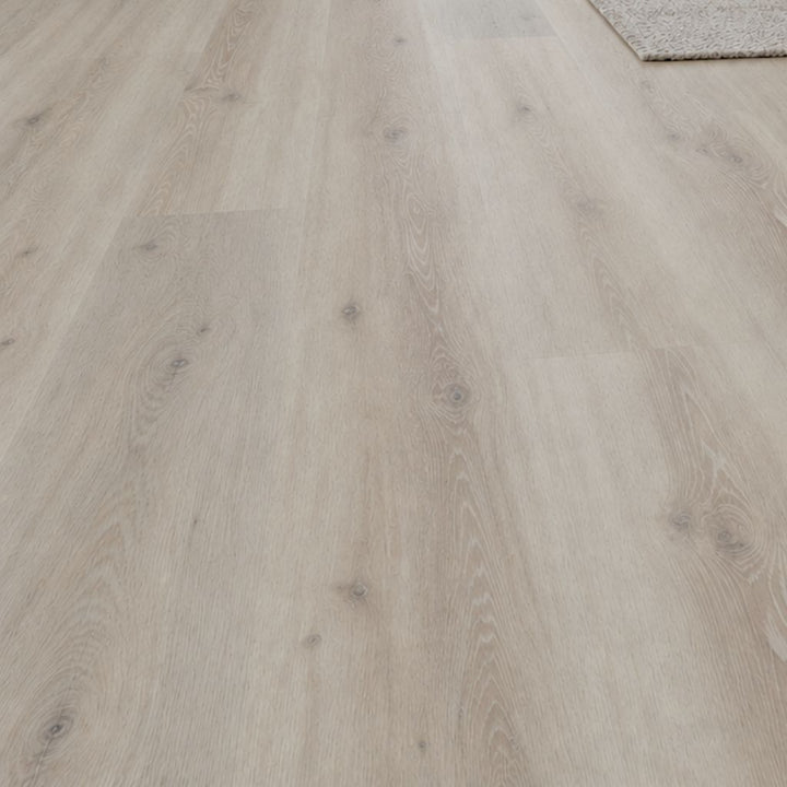 Nahaufnahme von Klick Vinyl Eiche Name in heller, grau-beiger Holzoptik mit Maserung und Ästen von Reud Bodenarena